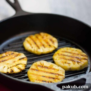 Grilled Pineapple slices and fresh ingredients for Spicy Grilled Pineapple Salsa.