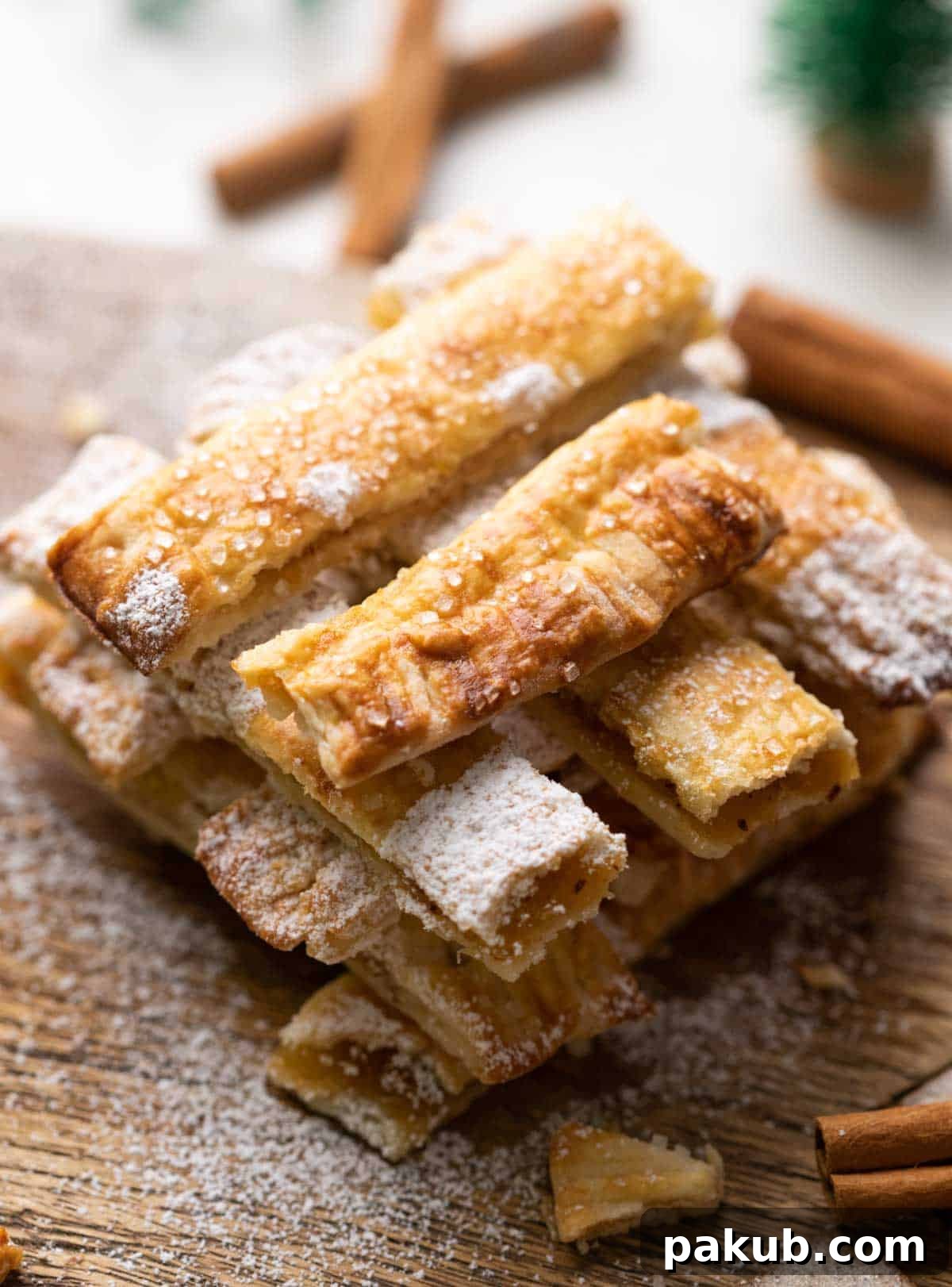 Delicious Apple Pie Chips with Caramel Sauce Crispy Apple Pie Chips, elegantly stacked on a rustic wooden board, accompanied by a decadent salted caramel sauce for dipping.