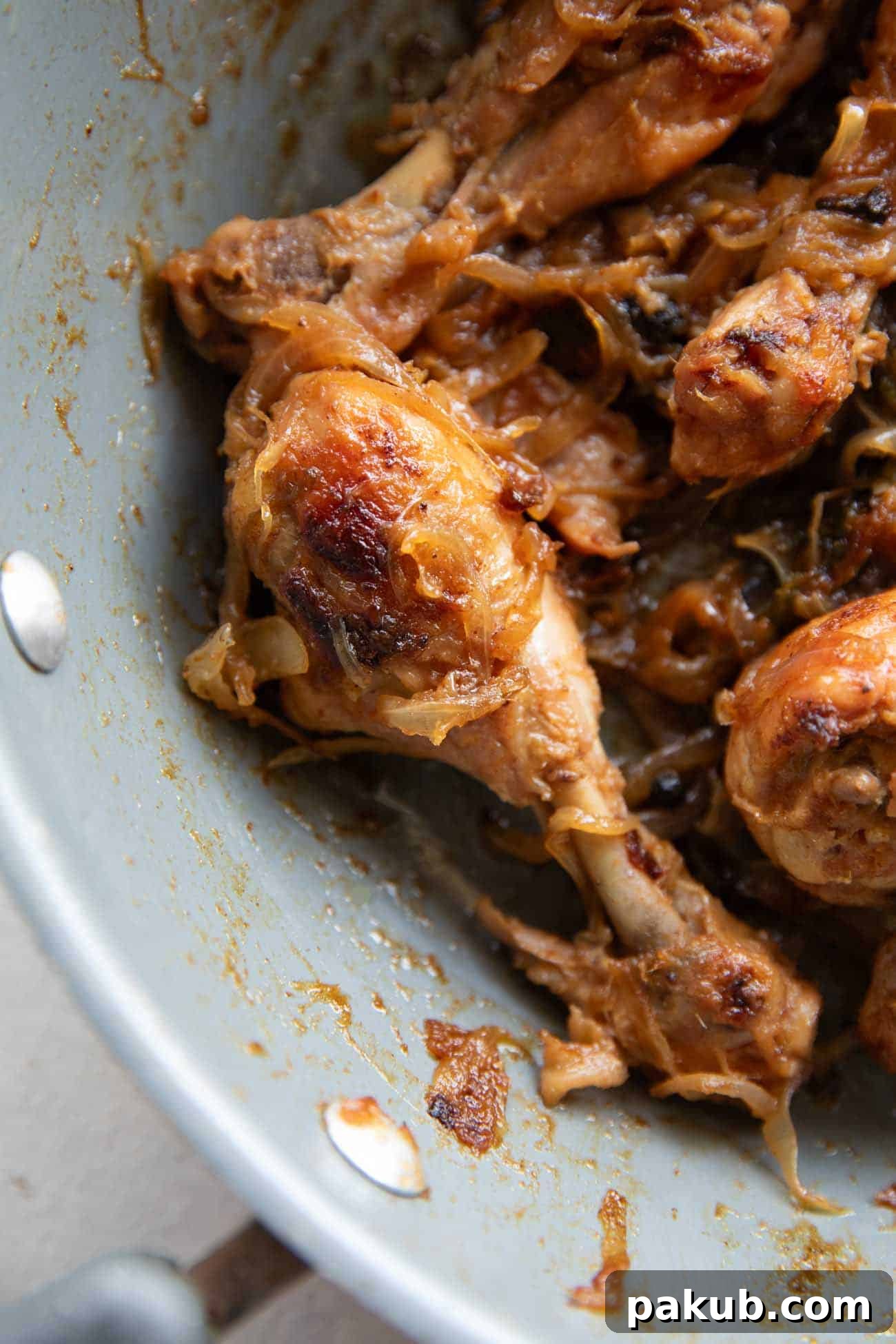 Caramelized Onion Chicken Roast Golden-brown chicken with deeply caramelized onions in a rustic pan, ready to serve.