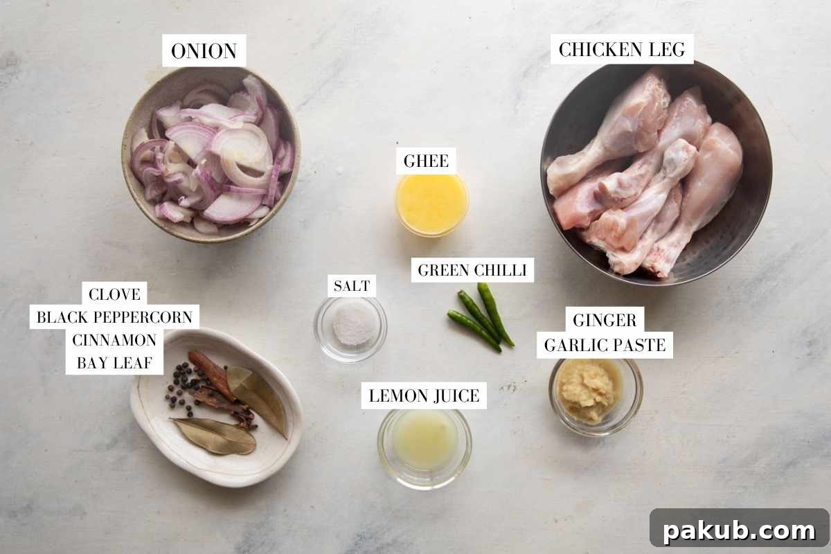Sweet Onion Roasted Chicken 2 Arrangement of fresh ingredients including chicken, sliced onions, ginger-garlic paste, spices, and green chilies on a rustic wooden board.