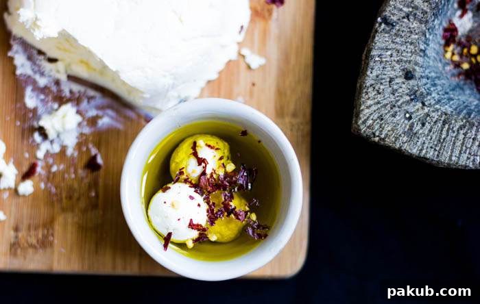 Crafting Delicious Cream Cheese at Home 5 A dish of homemade cream cheese drizzled with olive oil, surrounded by pita bread and fresh fruit, inviting a tasting experience.
