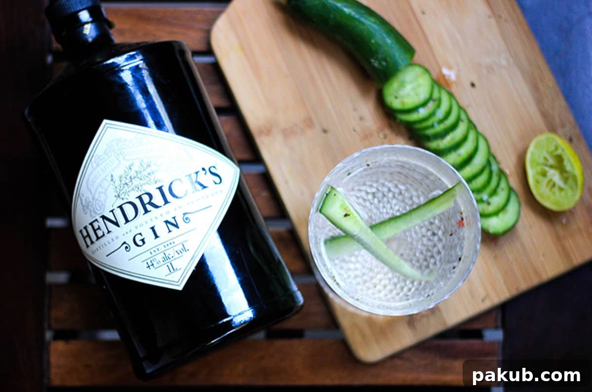 A selection of ingredients for the Sparkling Cucumber Chili Gin cocktail, including gin, cucumbers, and chili flakes.