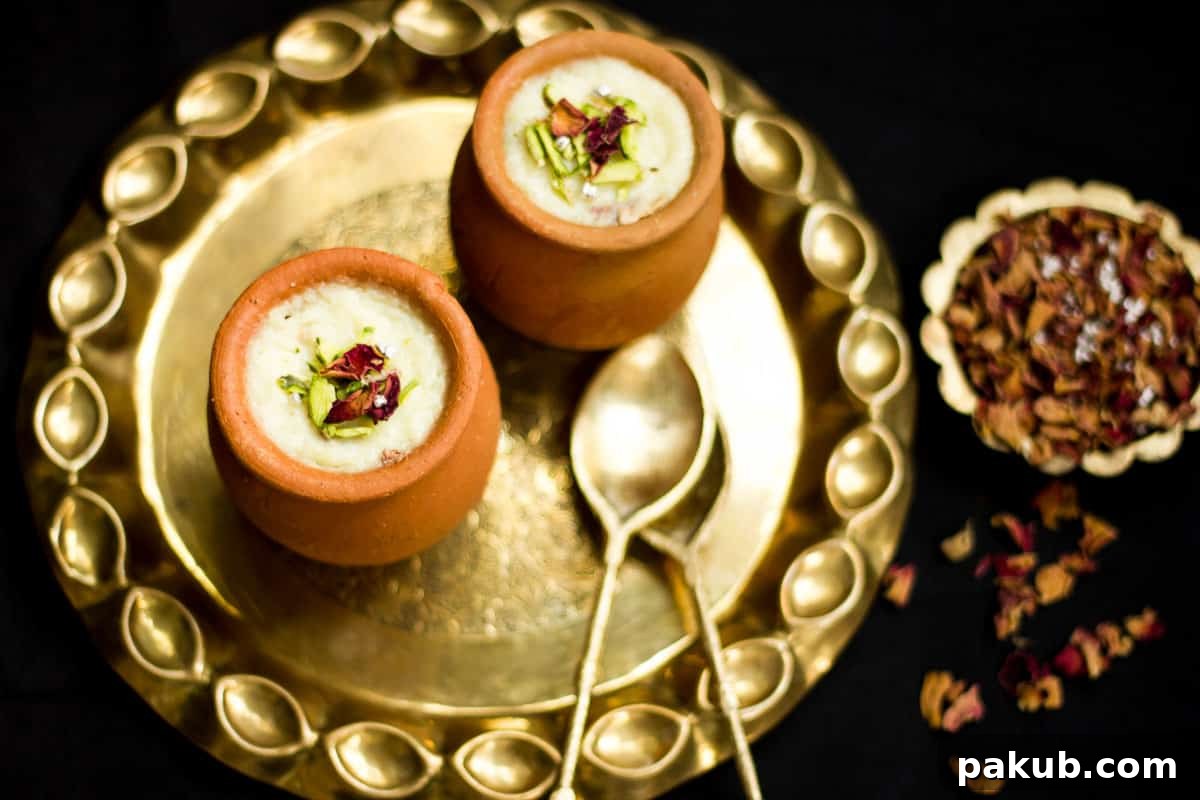 Mum's Creamy Rose Phirni 2 A beautifully presented bowl of Mum's Gulab Phirni, a rose flavored Indian rice pudding, garnished with pistachios and rose petals.