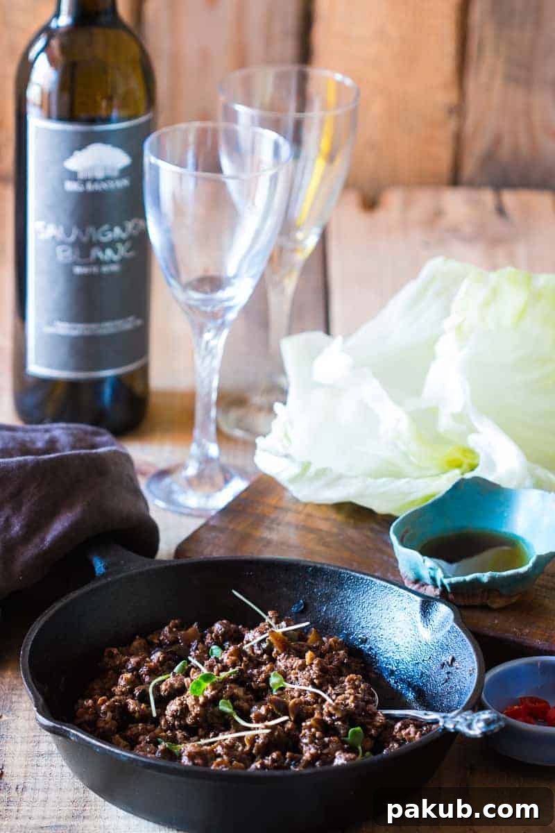 Delicious stir-fried black bean chicken filling ready to be spooned into fresh lettuce leaves. Ideal for a fast and healthy meal.