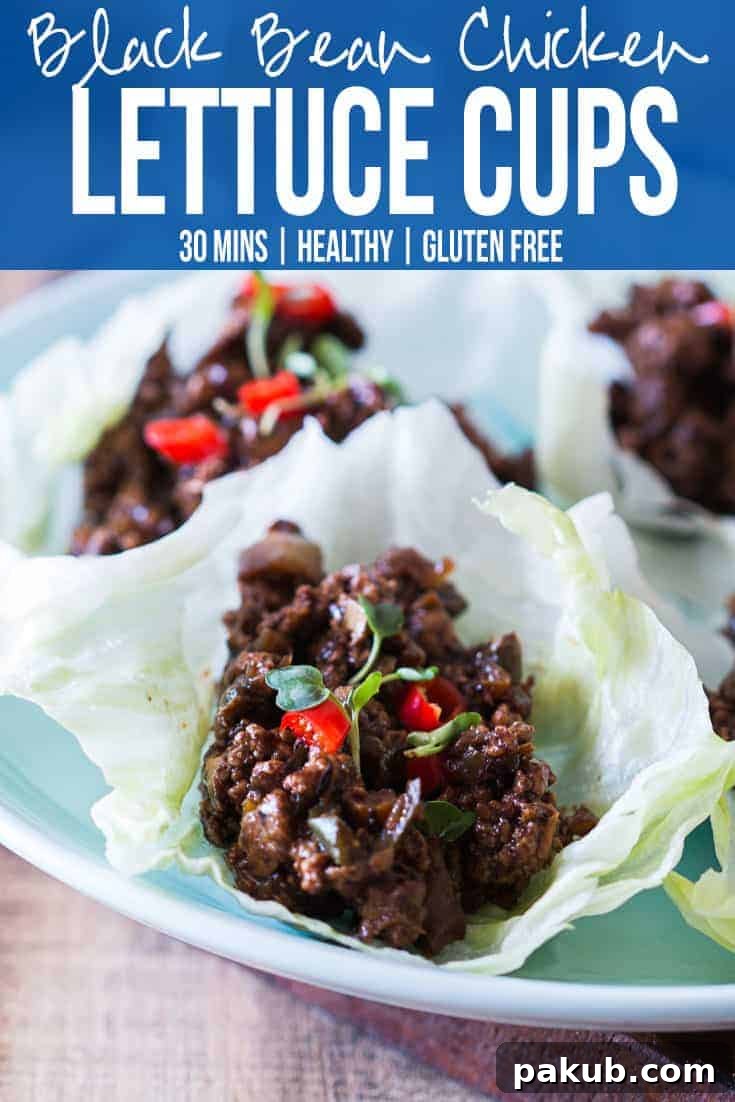 Stir-fried black bean chicken filling in a skillet, showcasing the rich texture and delicious aromas. Ready to be served in lettuce cups.