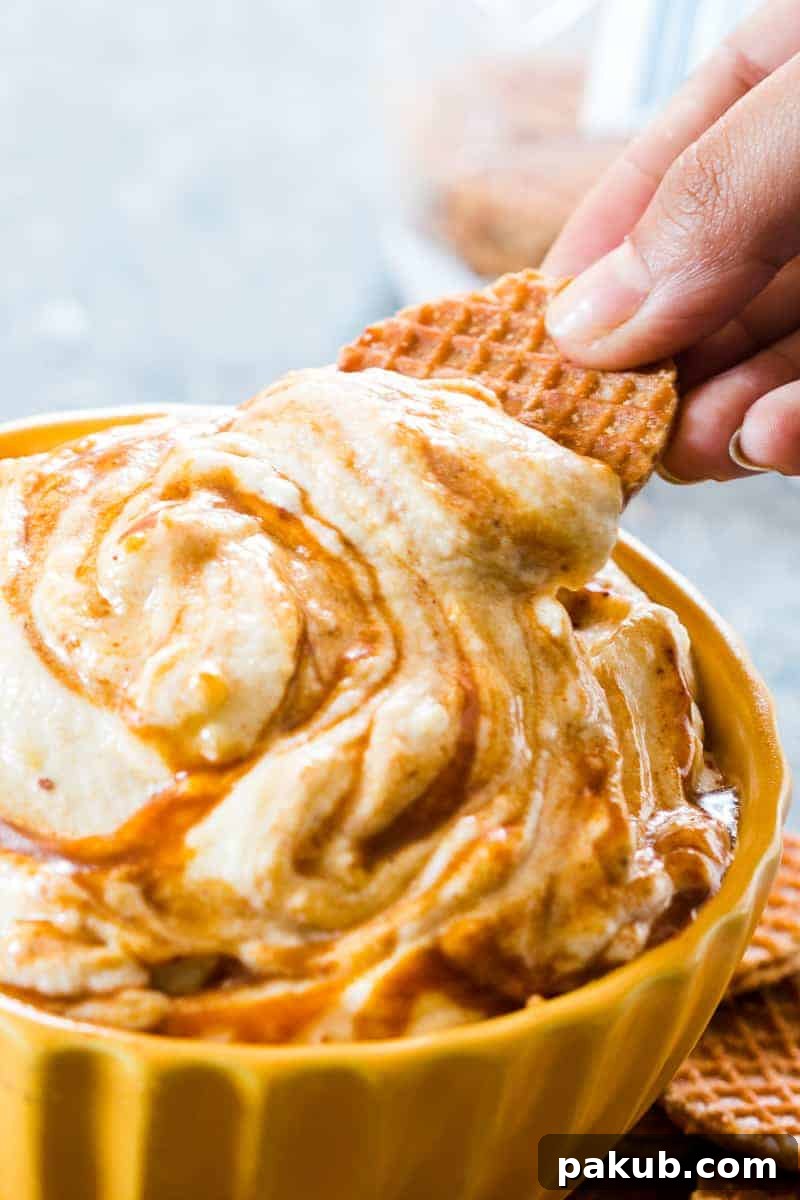 A closer look at the smooth, creamy texture of the Caramel Pumpkin Pie Cheesecake Dip, ready to be served with a selection of dippers.