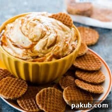 The finished Caramel Pumpkin Pie Cheesecake Dip, served in a bowl with a selection of crispy crackers for dipping.