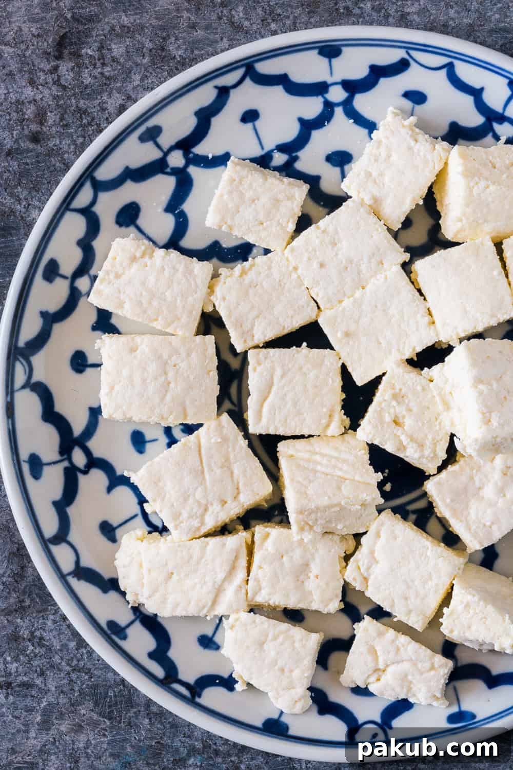 Here's step by step instructions to make homemade Indian paneer (cottage cheese) in just 15 minutes. The next time you want to make saag paneer, palak paneer, makhani, tikka or matar paneer, don't buy store bought and just make this at home with 2 ingredients. 