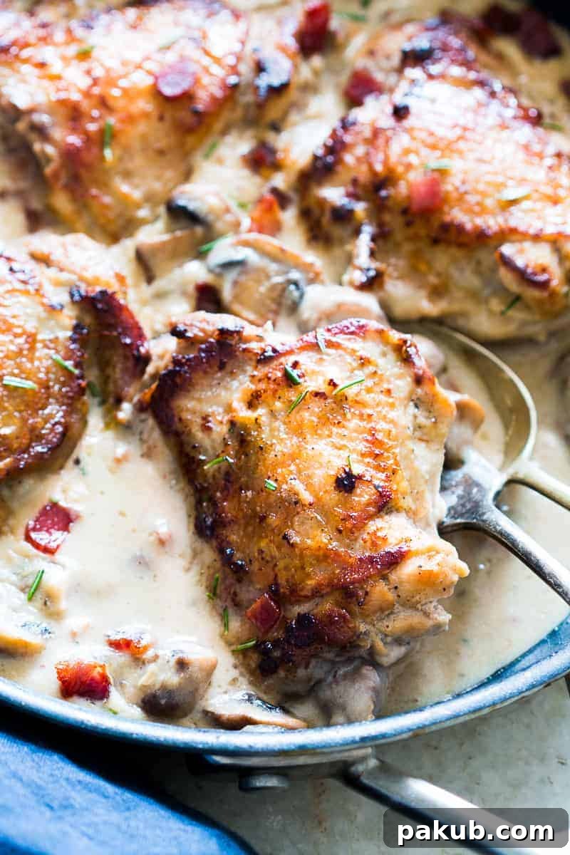These creamy bacon rosemary mushroom chicken thighs are going to be your favorite weeknight comfort food. Chicken thighs are simmered in a lightened up alfredo like bacon sauce with mushrooms and rosemary. Serve it with pasta, or if you are looking for a low carb version, just add some steamed broccoli on the side. 