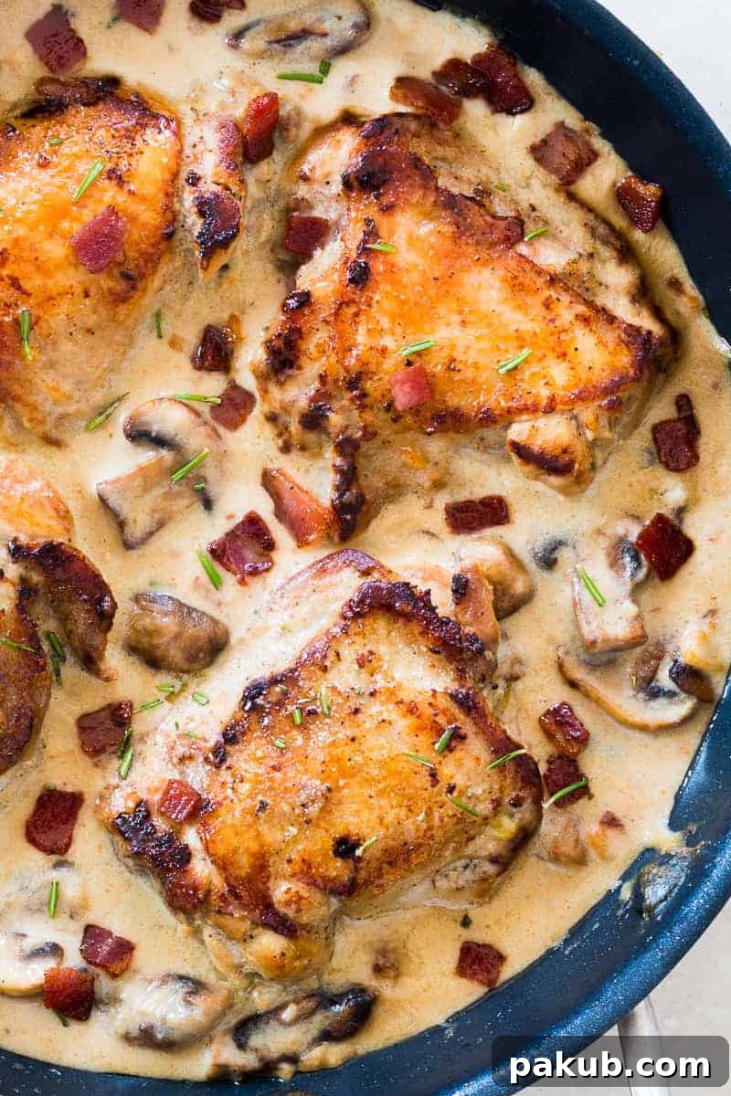 These creamy bacon rosemary mushroom chicken thighs are going to be your favorite weeknight comfort food. Chicken thighs are simmered in a lightened up alfredo like bacon sauce with mushrooms and rosemary. Serve it with pasta, or if you are looking for a low carb version, just add some steamed broccoli on the side. 