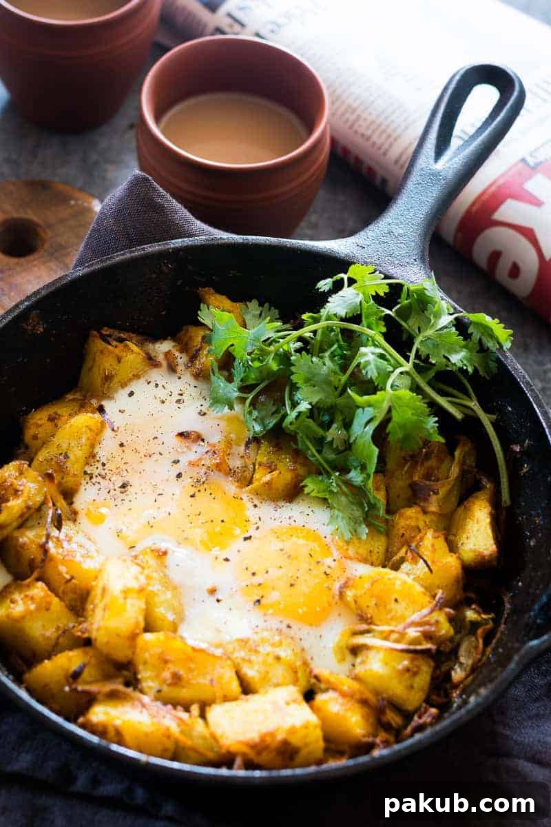 Spiced Indian Potatoes and eggs are cooked in a skillet for a hearty and easy holiday morning breakfast recipe. Perfect for a crowd, kid friendly and gluten free.