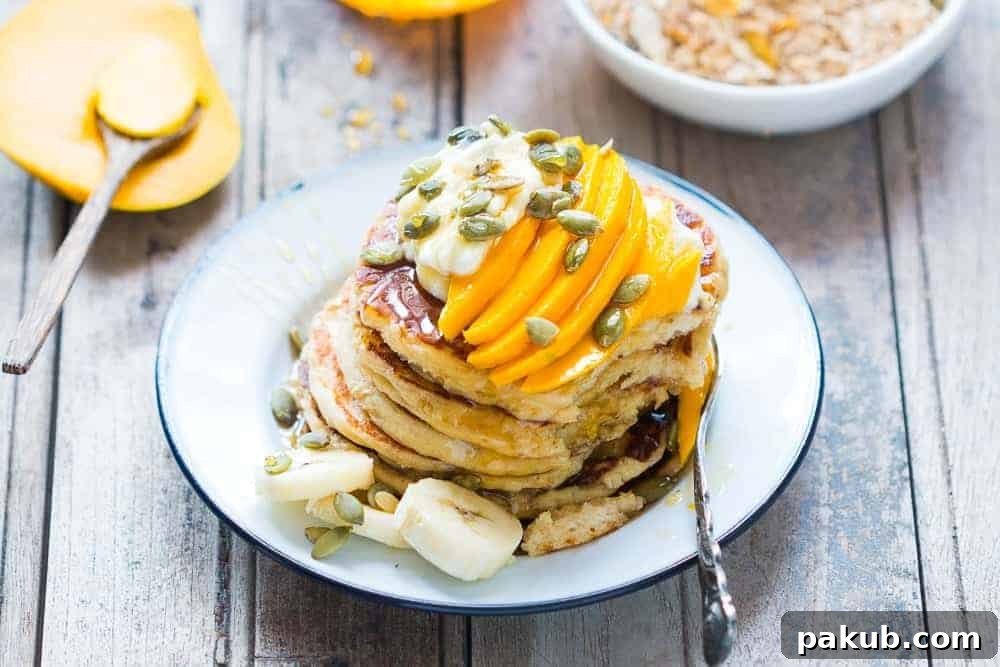 Get the recipe for the fluffiest gluten free oatmeal cottage cheese pancakes and you won't be able to tell that they are also eggless! Topped with mango yogurt and mixed nuts.