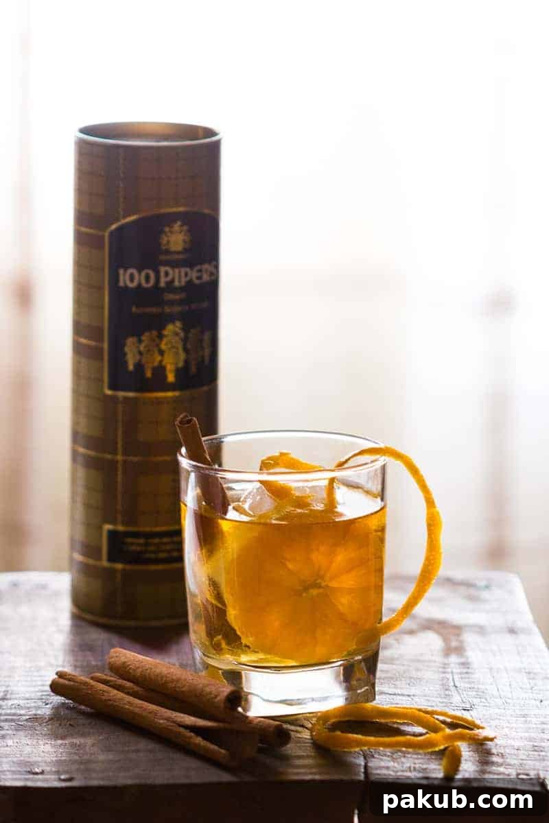 Step-by-step preparation of the Orange Cinnamon Whisky Smash, showcasing fresh oranges and cinnamon sticks.