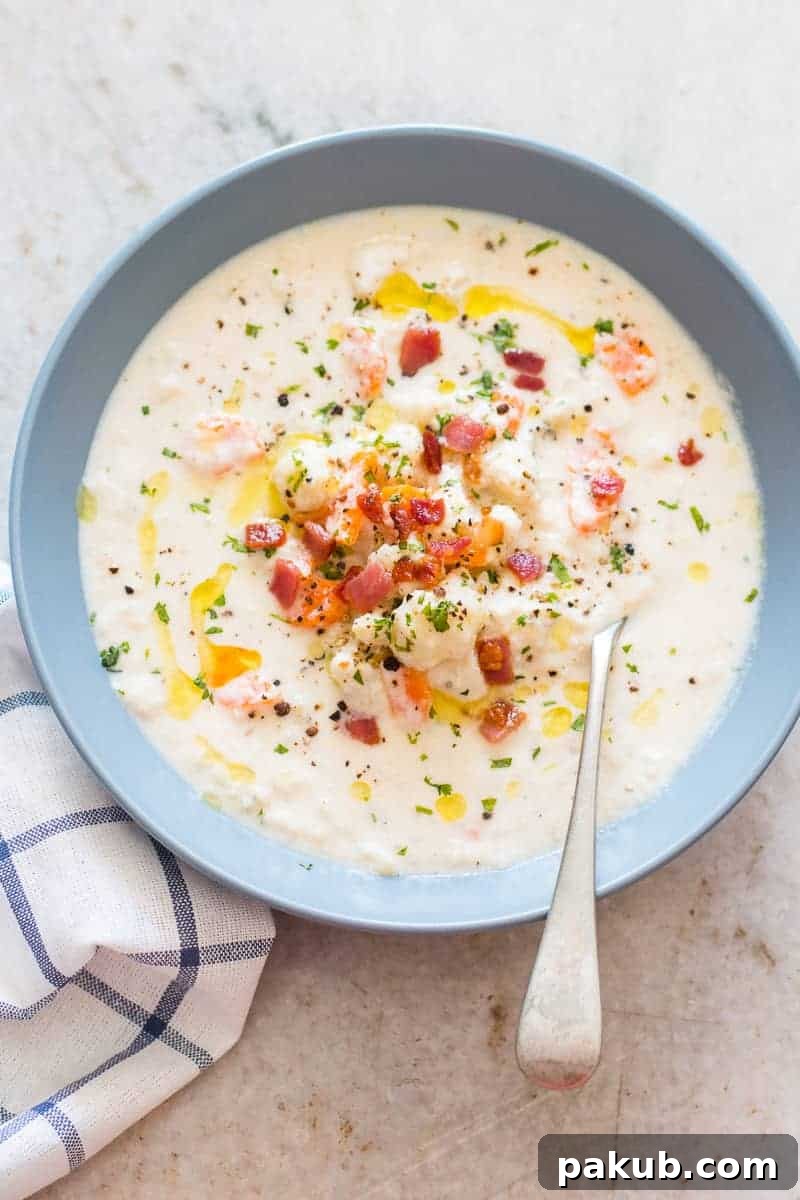 Effortless Creamy Cauliflower Chowder 4 Freshly cooked Creamy Cauliflower Chowder in a rustic bowl, ready to be served. This healthy, easy, comfort food recipe is gluten-free, low-carb, and keto-friendly.