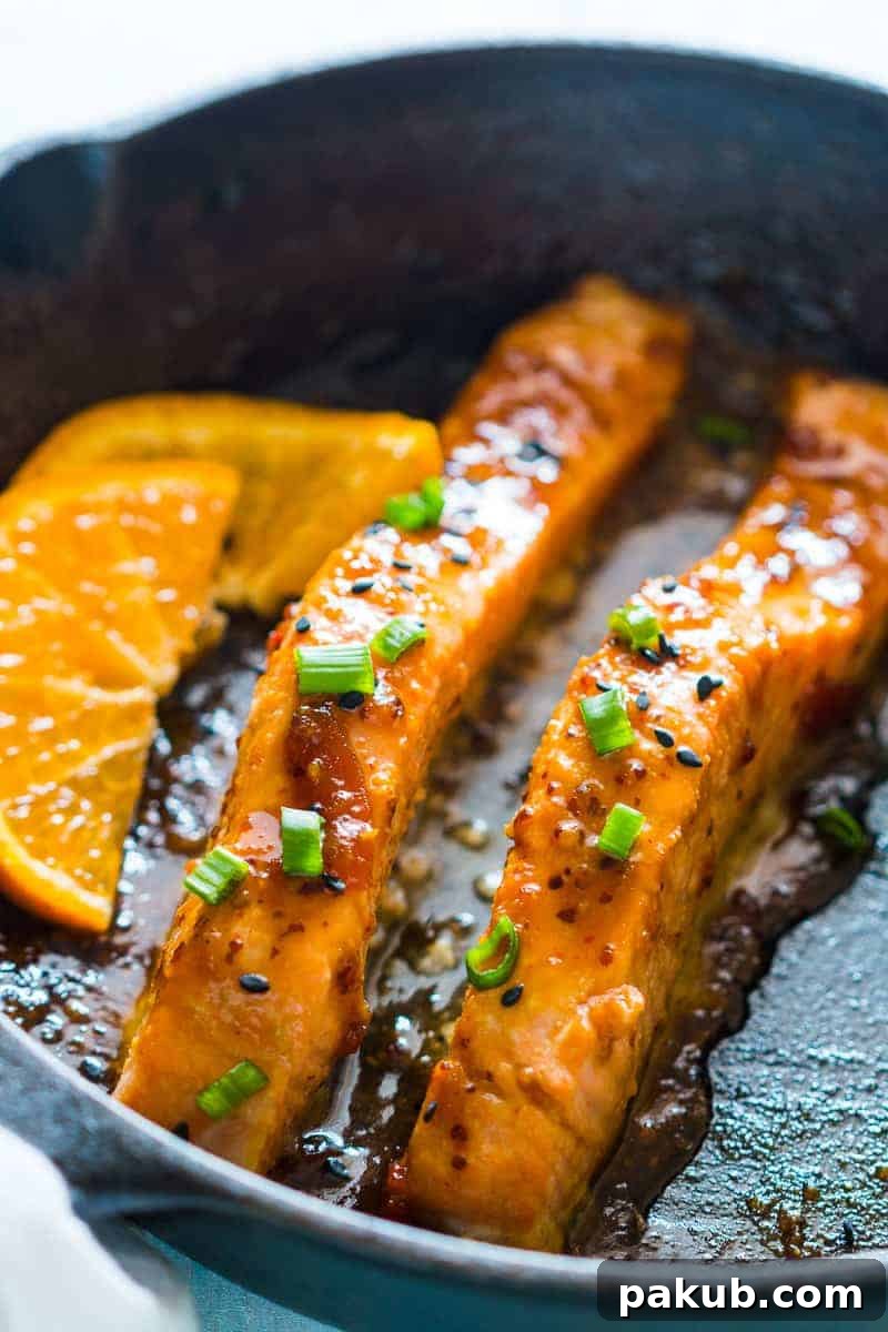 Sizzling Salmon with Orange-Mustard Glaze 2 Perfectly pan-seared orange mustard salmon fillets glistening with glaze, ready to be served, highlighting the crispy skin and vibrant sauce.