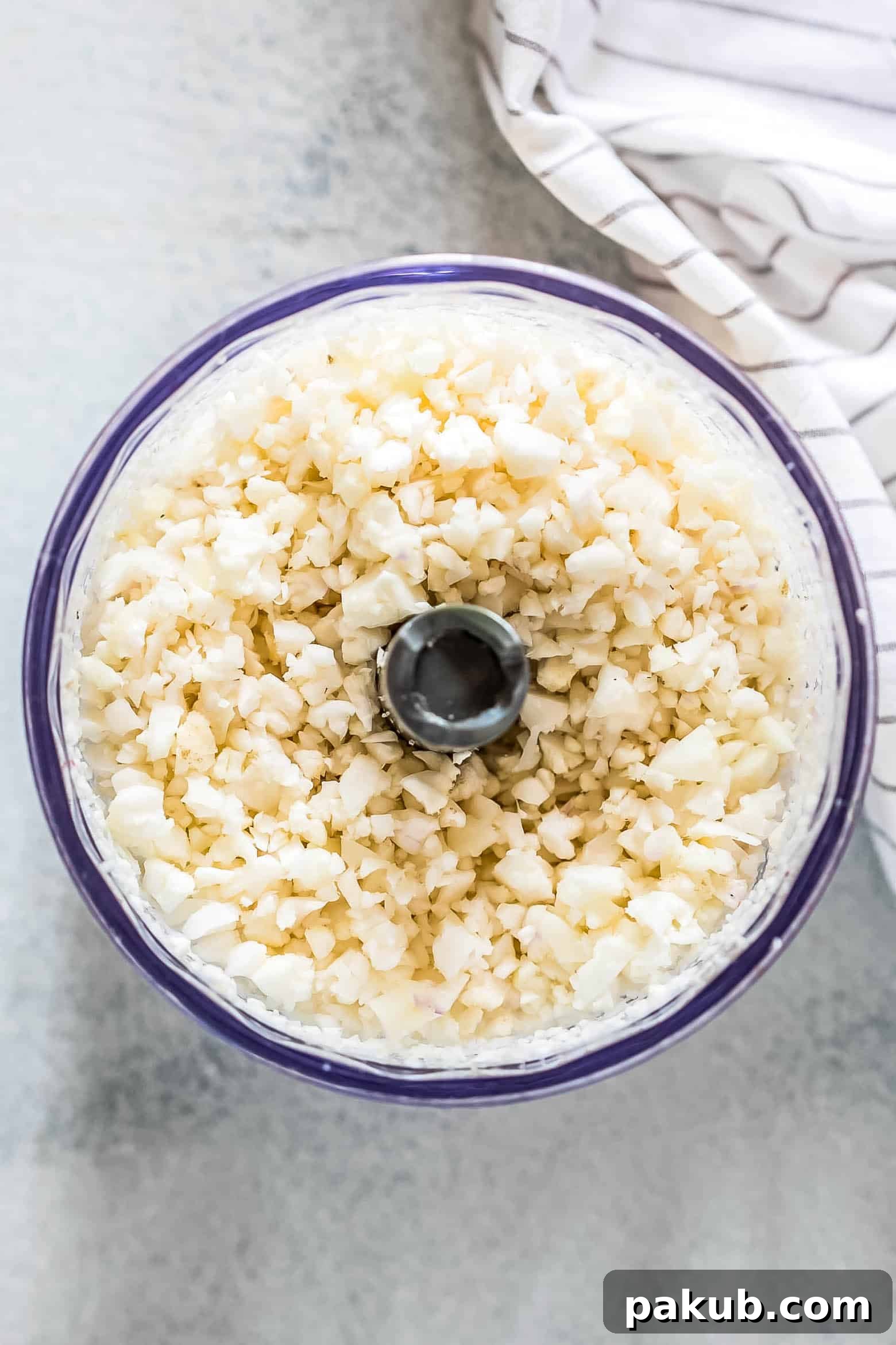 Close-up of Mexican Cauliflower Rice in a pan, showing diced vegetables and rich seasoning, ready to be served.