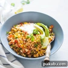 Low Carb Mexican Cauliflower Rice topped with sour cream and avocados.