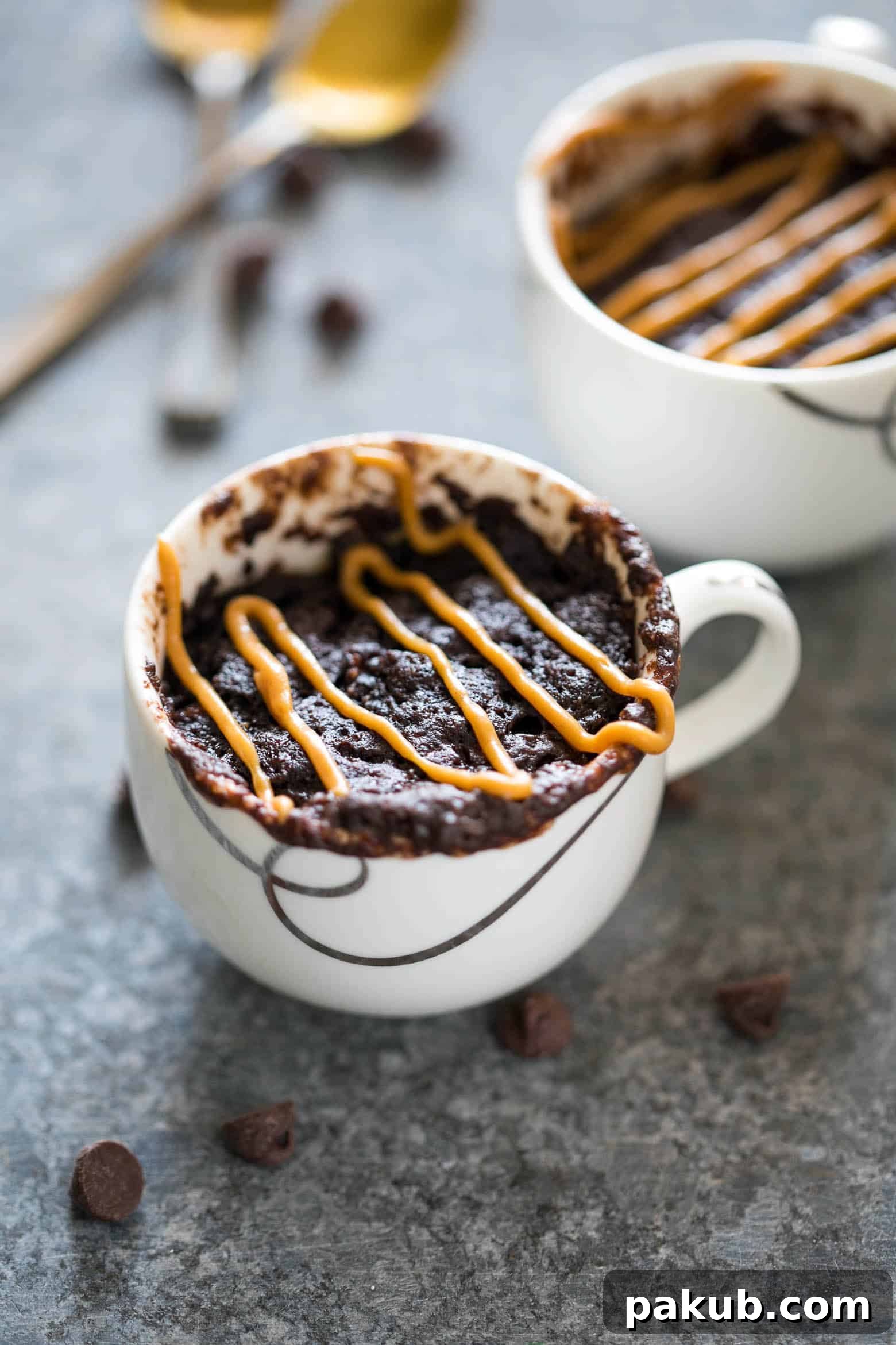 Luscious Eggless Banana Chocolate Peanut Butter Mug Cake 3 Delicious Eggless Banana Chocolate Peanut Butter Mug Cake, topped with extra peanut butter.