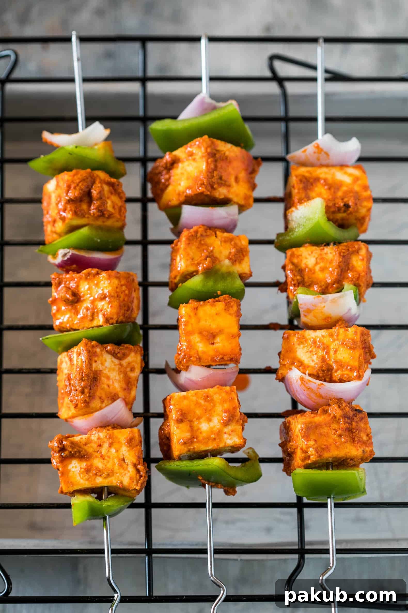 Oven-Baked Tandoori Paneer Tikka 3 Marinated paneer and vegetable cubes on skewers, ready for oven roasting to create the best homemade Tandoori Paneer Tikka.