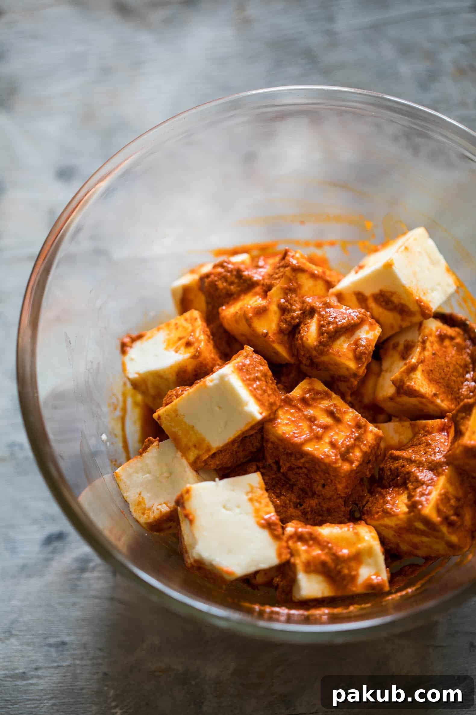 Oven-Baked Tandoori Paneer Tikka 4 Close-up of the vibrant red marinade coating paneer cubes, showcasing the rich color from natural spices like Kashmiri Red Chilli Powder.