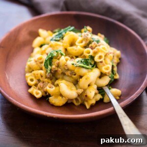 Creamy pumpkin sausage mac and cheese with kale is pure comfort food! It's a fast, easy dinner recipe when you crave homemade pasta.