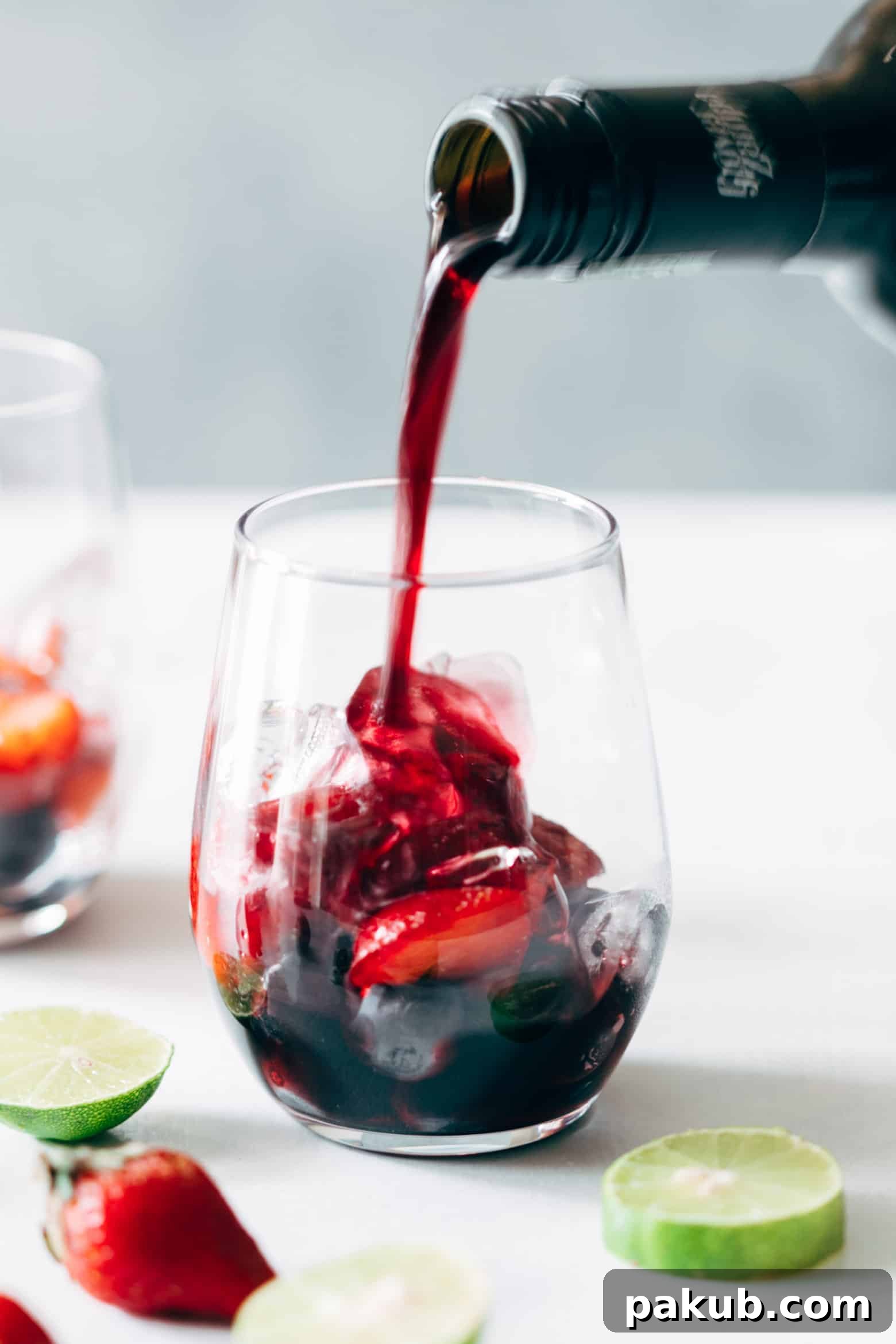 The Summer Berry Red Wine Spritzer, showcasing the beautiful red hue of the wine and the delicate inclusion of strawberries.