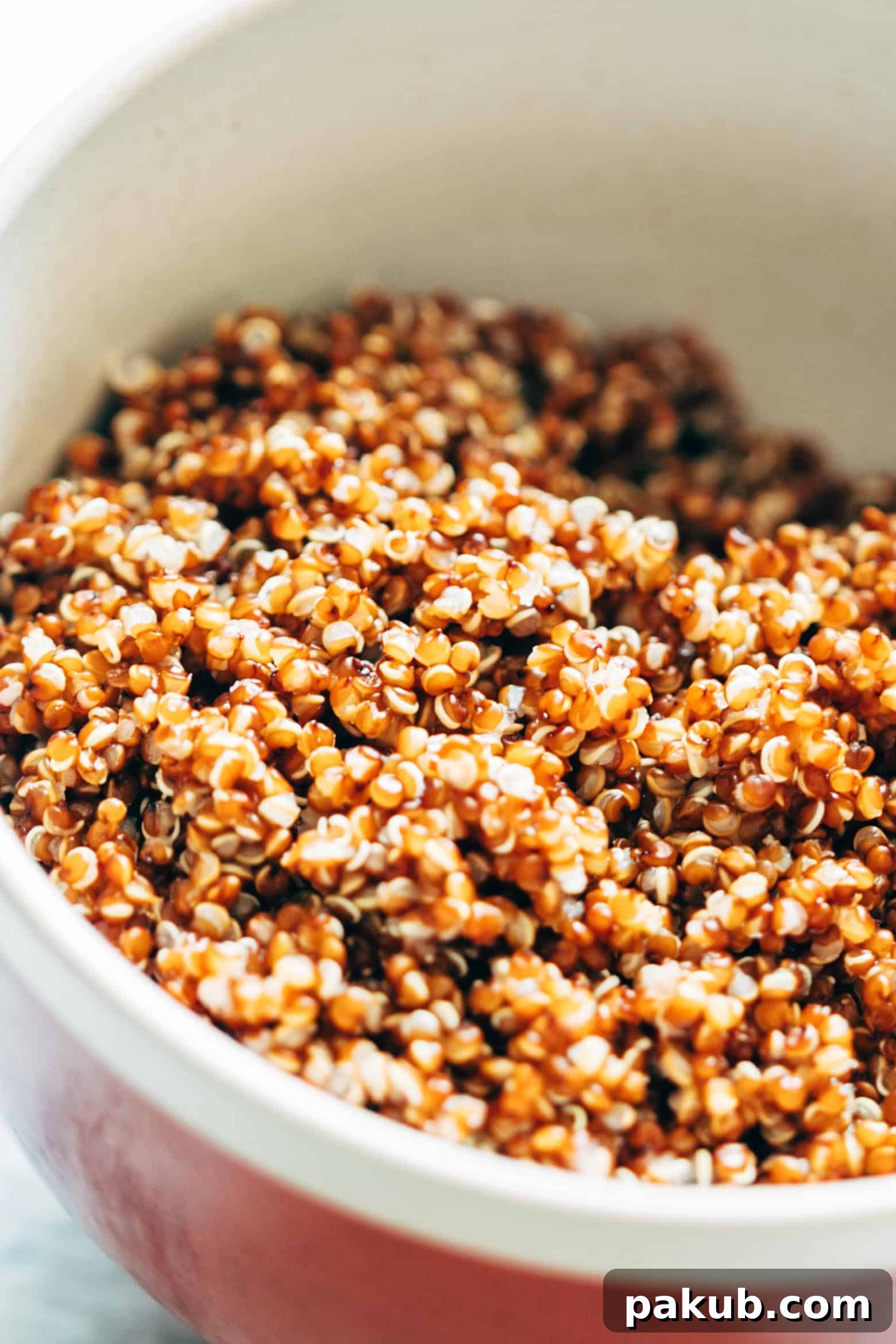Freshly prepared Thai Peanut Mango Quinoa Salad, a healthy, gluten-free, and vegan option for gatherings, featuring a delightful sambal dressing.