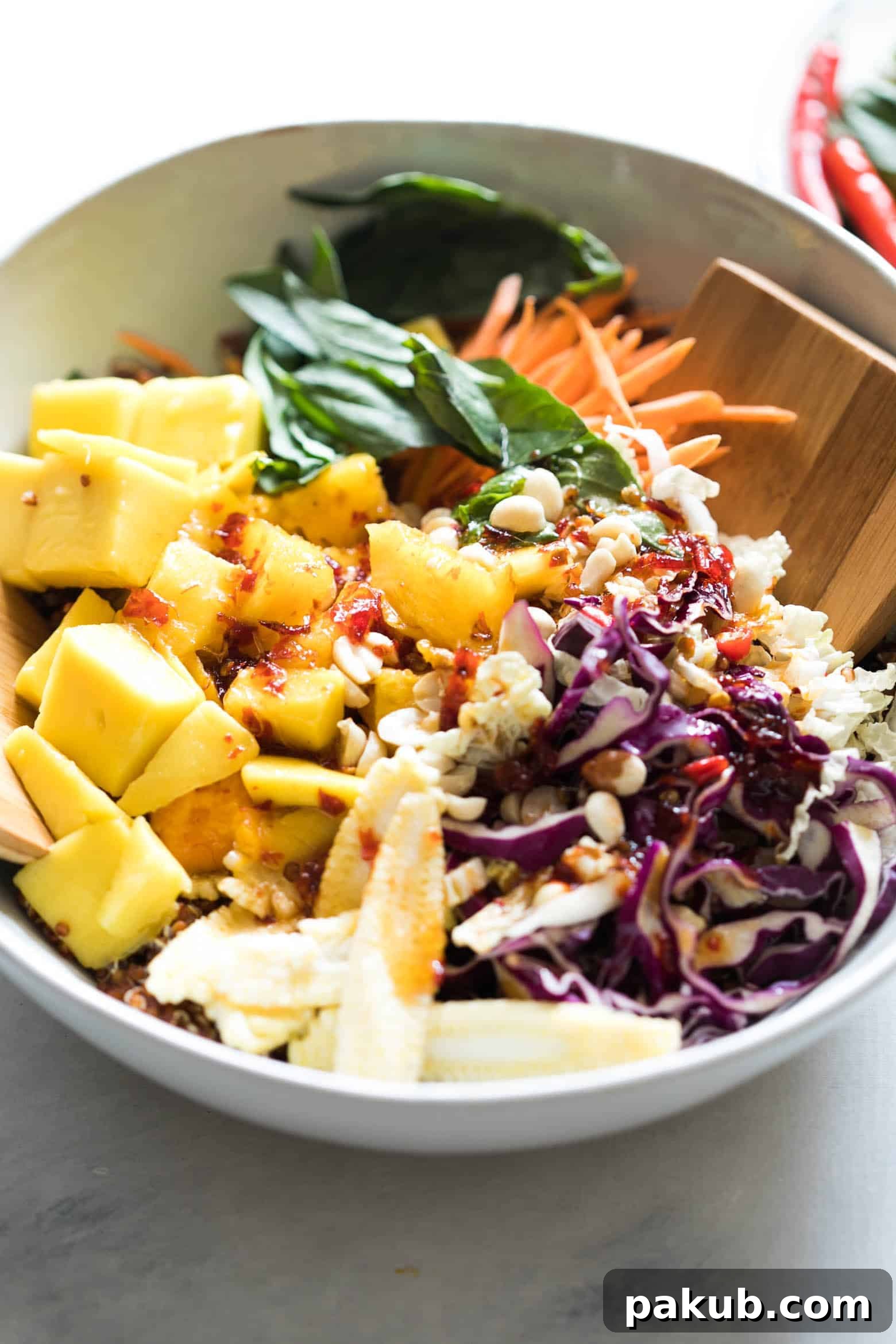 Generous serving of Thai Peanut Mango Quinoa Salad, emphasizing its vibrant colors and fresh ingredients, ideal for a healthy meal.