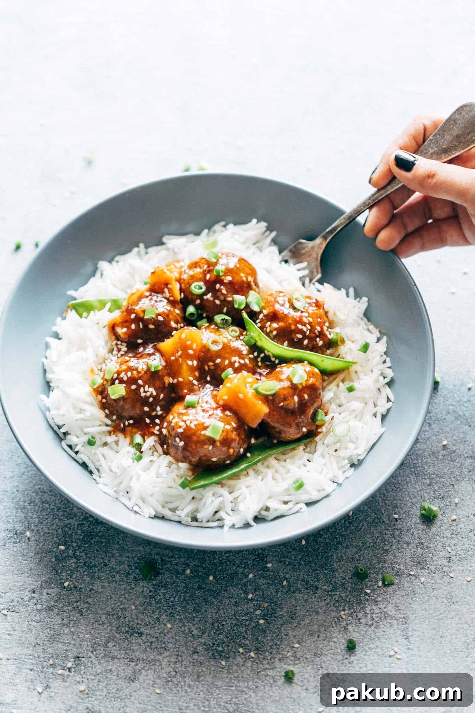 Delicious Asian inspired slow cooker teriyaki meatballs with pineapple, served in a bowl, highlighting their juicy texture and rich sauce. Perfect for a quick and flavorful meal, these meatballs can be easily prepared in a crockpot or baked.