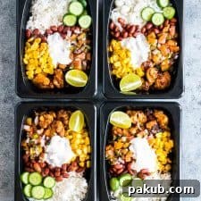 Chicken Burrito meal made ahead for the week and stored in a black refrigerator and microwave friendly box!