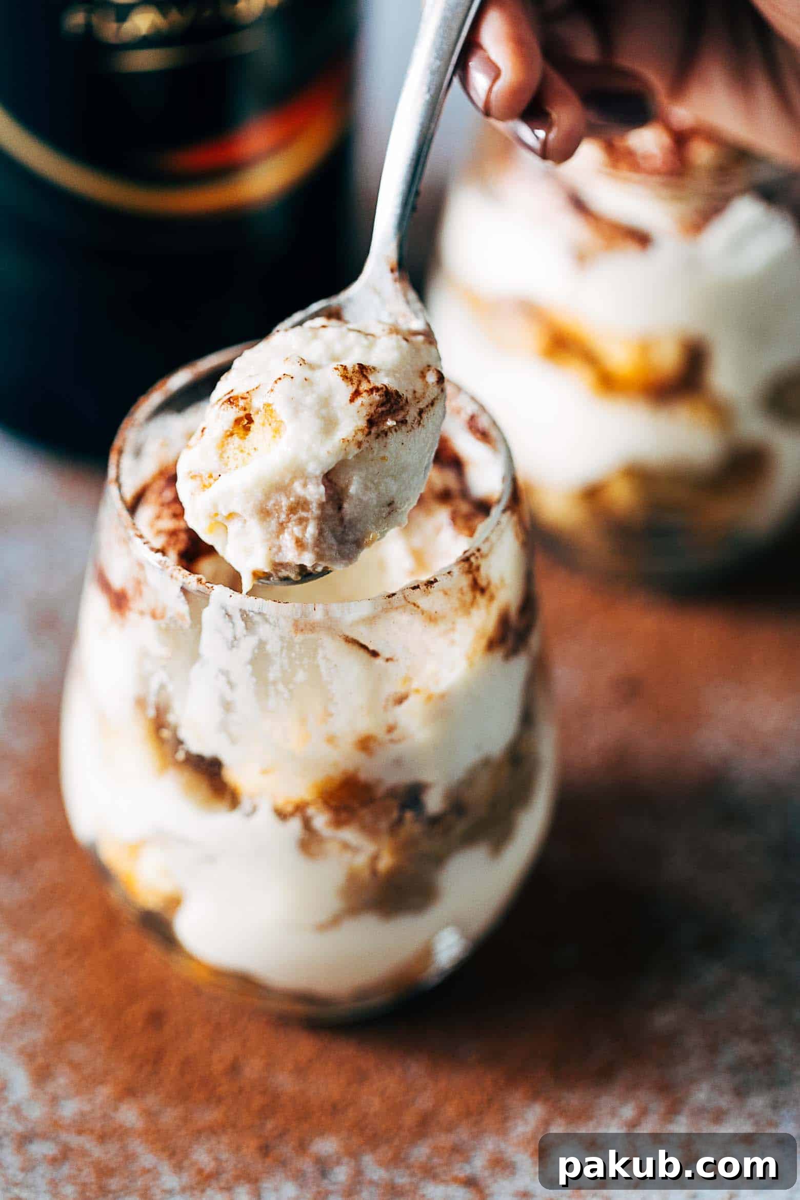 Delicious Baileys Tiramisu Trifle Cups in individual glasses, ready to be enjoyed, showing the perfect layers and cocoa dusting.