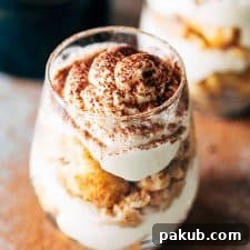 Baileys Tiramisu seasoned with coffee powder and served in a glass.