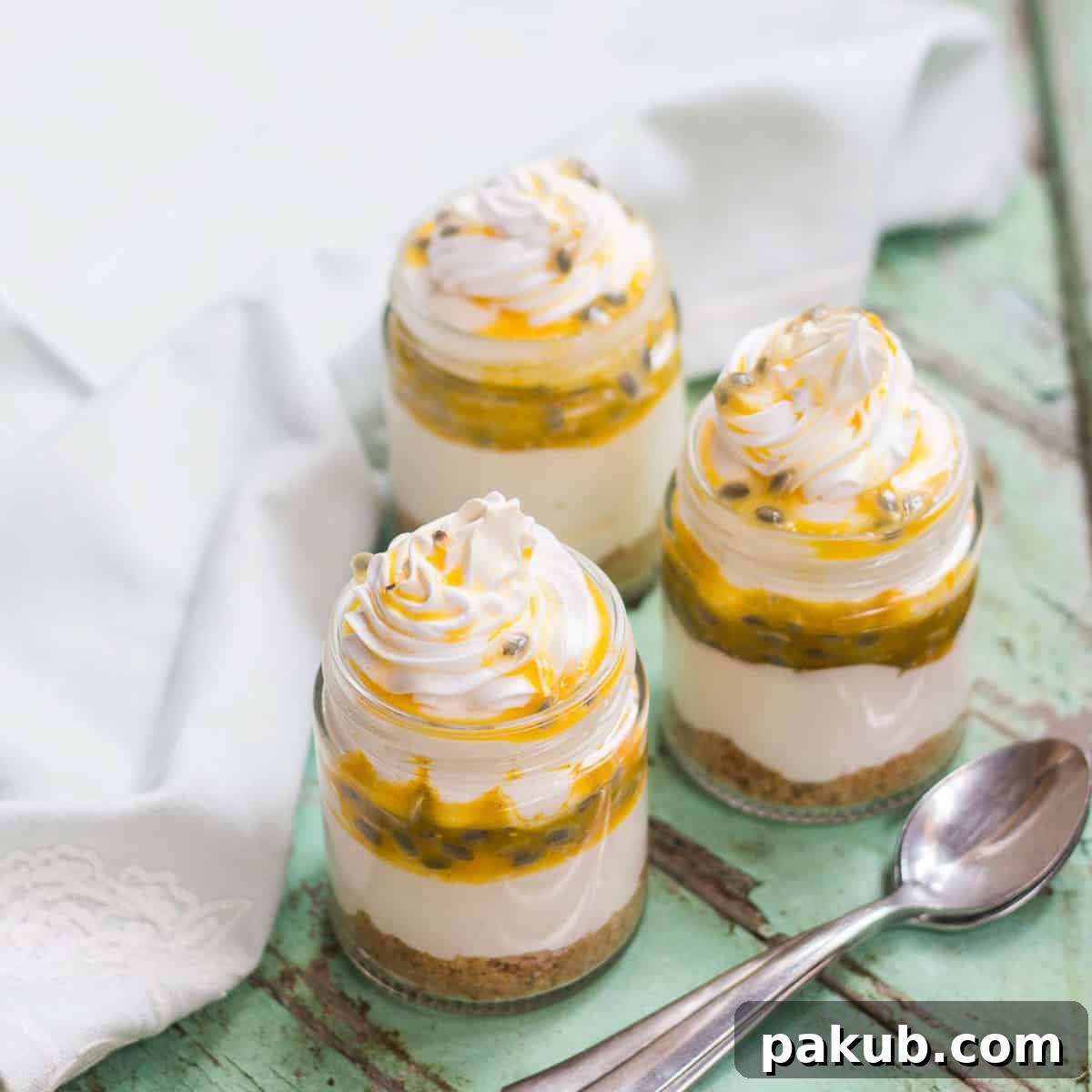 Vibrant 8-ingredient Passion Fruit Cheesecake Jars, layered with creamy cheesecake and tangy passion fruit, perfect for a refreshing individual dessert.