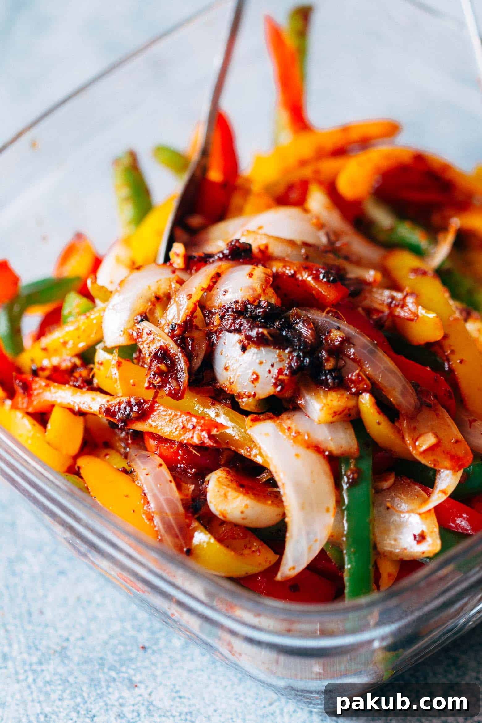Individual glass containers filled with chicken fajitas, bell peppers, and cilantro lime quinoa, neatly arranged for grab-and-go weekday lunches.