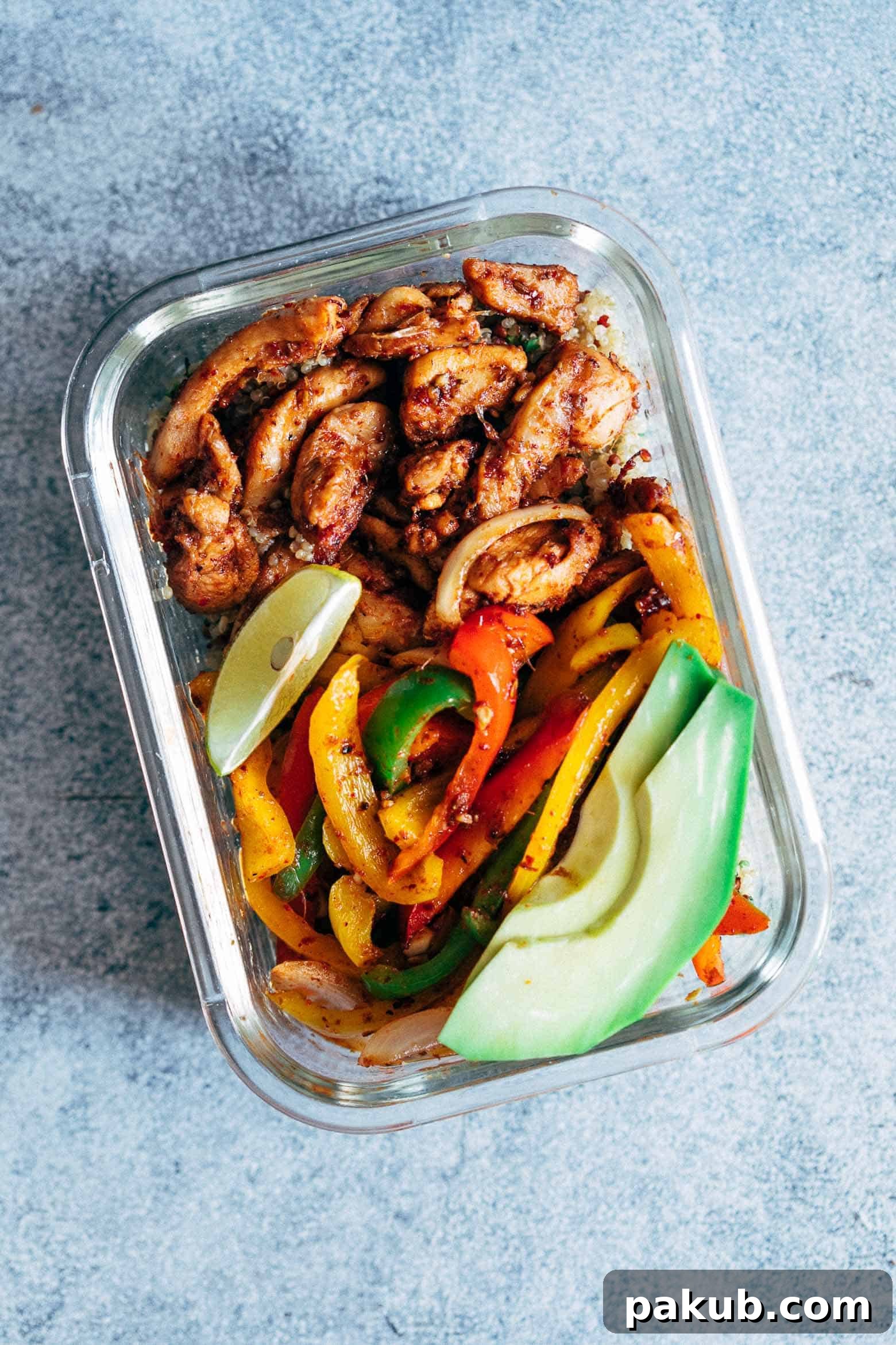 Close-up of three glass meal prep containers showcasing the neatly portioned chicken fajitas, bell peppers, and cilantro lime quinoa, ready for the week.