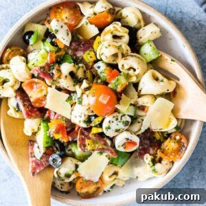 Italian Antipasto Tortellini Pasta Salad put together in a white bowl.