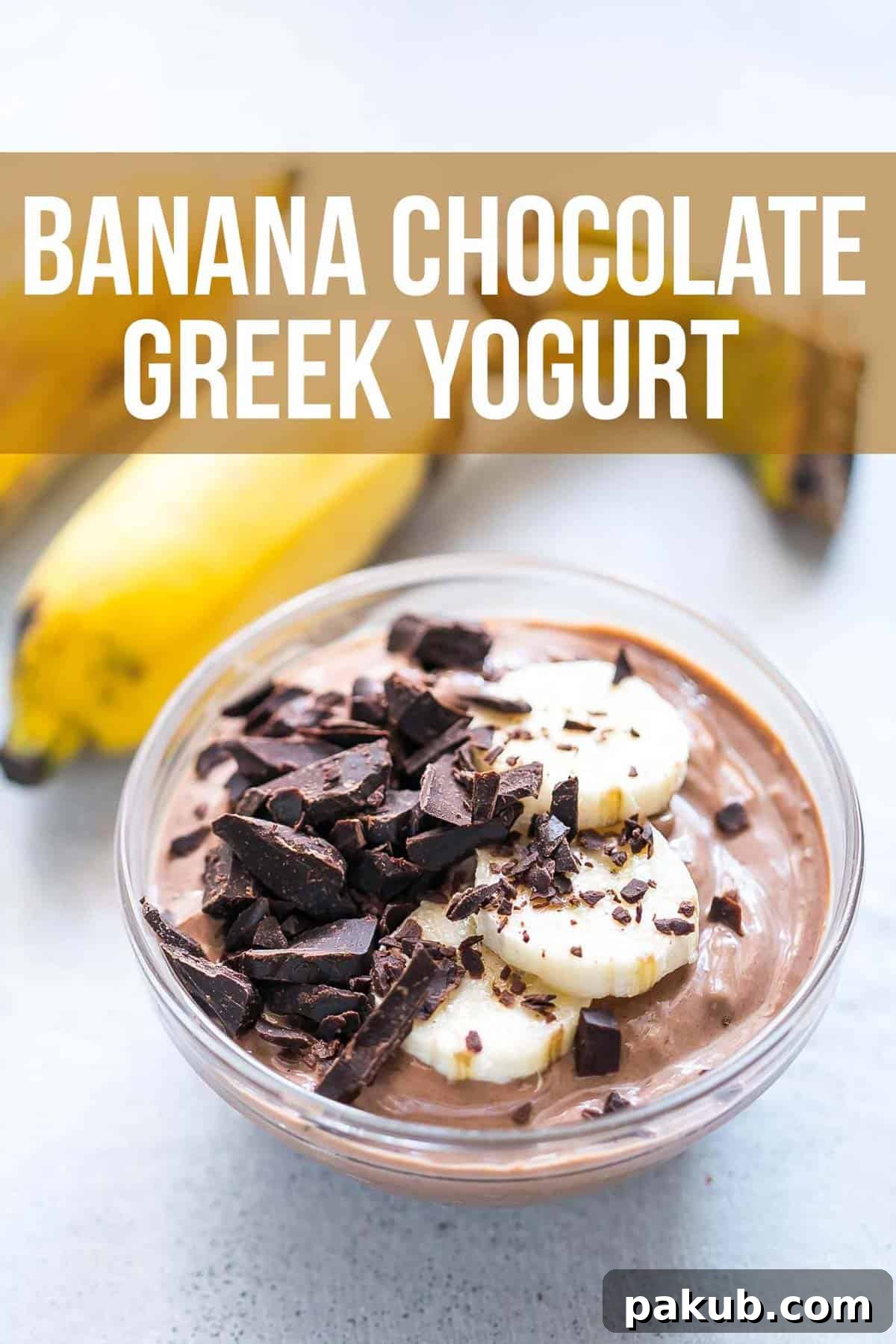 Banana chocolate Greek yogurt served in a bowl, generously topped with grated chocolate and slices of fresh banana.