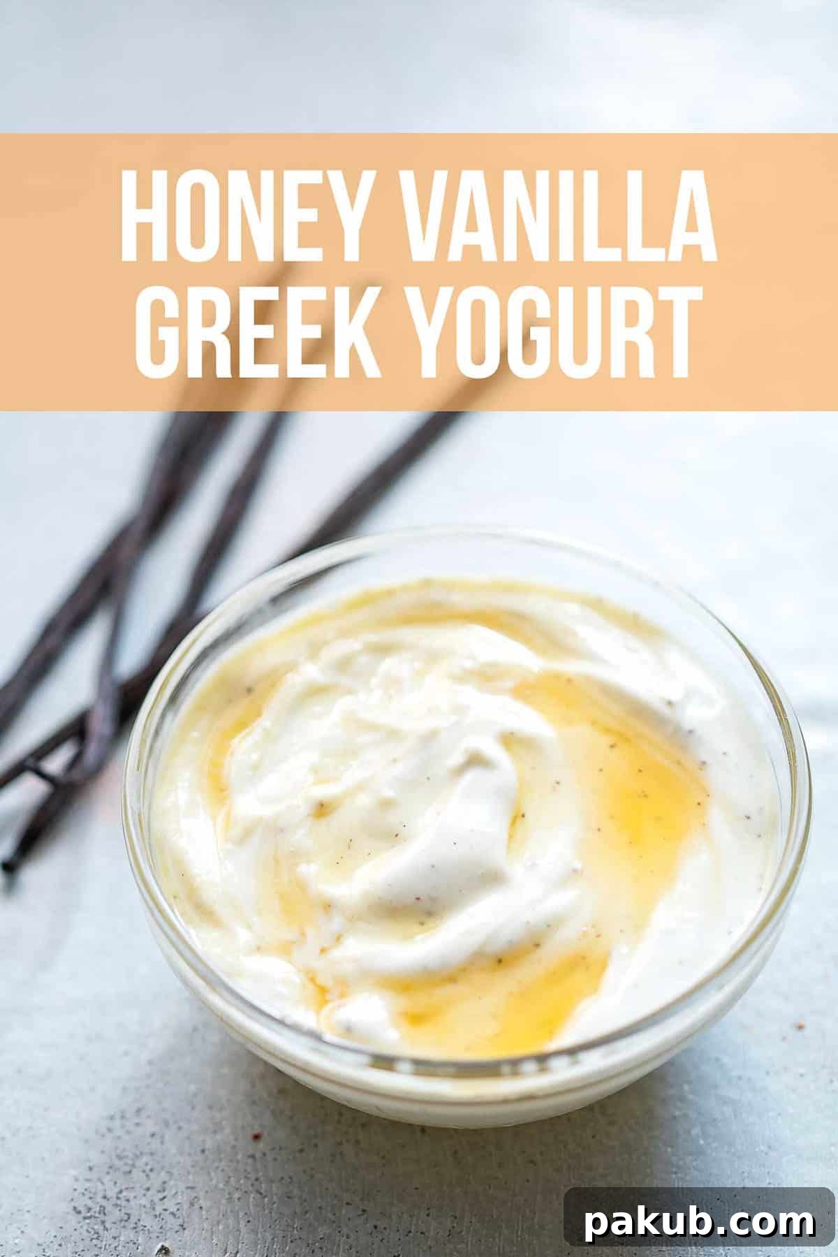 Creamy honey vanilla Greek yogurt drizzled with golden honey, accompanied by vanilla pods, served elegantly in a bowl.