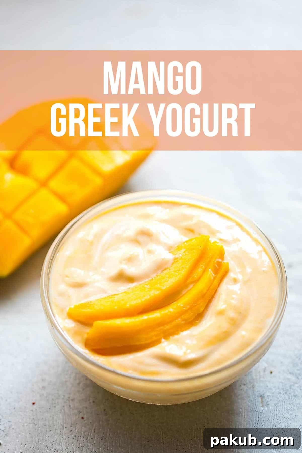 Creamy mango Greek yogurt served in a bowl, garnished with fresh mango slices on top.