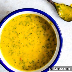 Zesty Mango Cilantro Salad Dressing Gluten Free 5 A creamy and smooth Mango Cilantro Salad Dressing in a blue and white bowl, ready to be served.