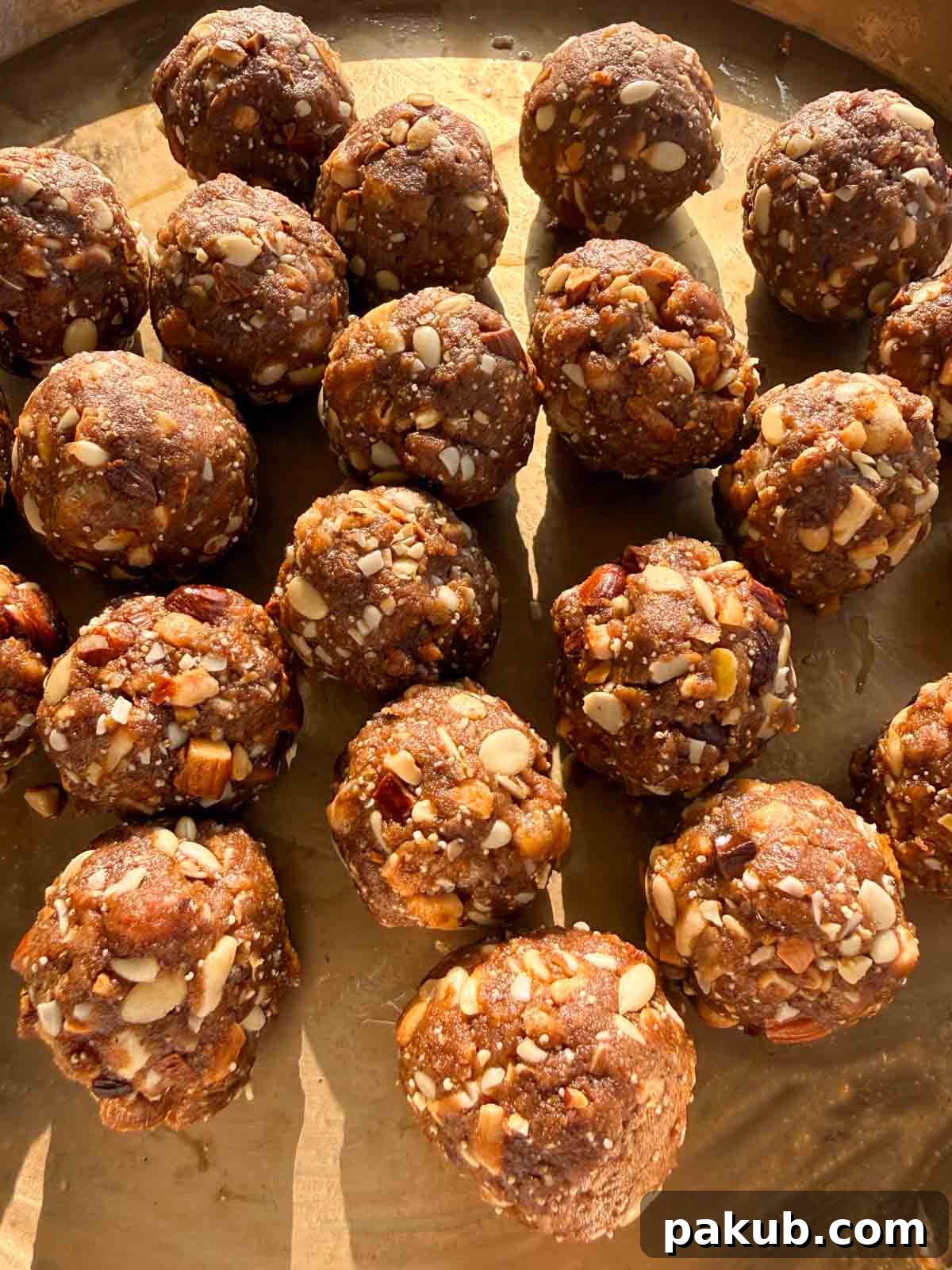 A close-up view of Gond Ke Laddu, highlighting their crumbly yet firm texture and the visible pieces of nuts and gond.