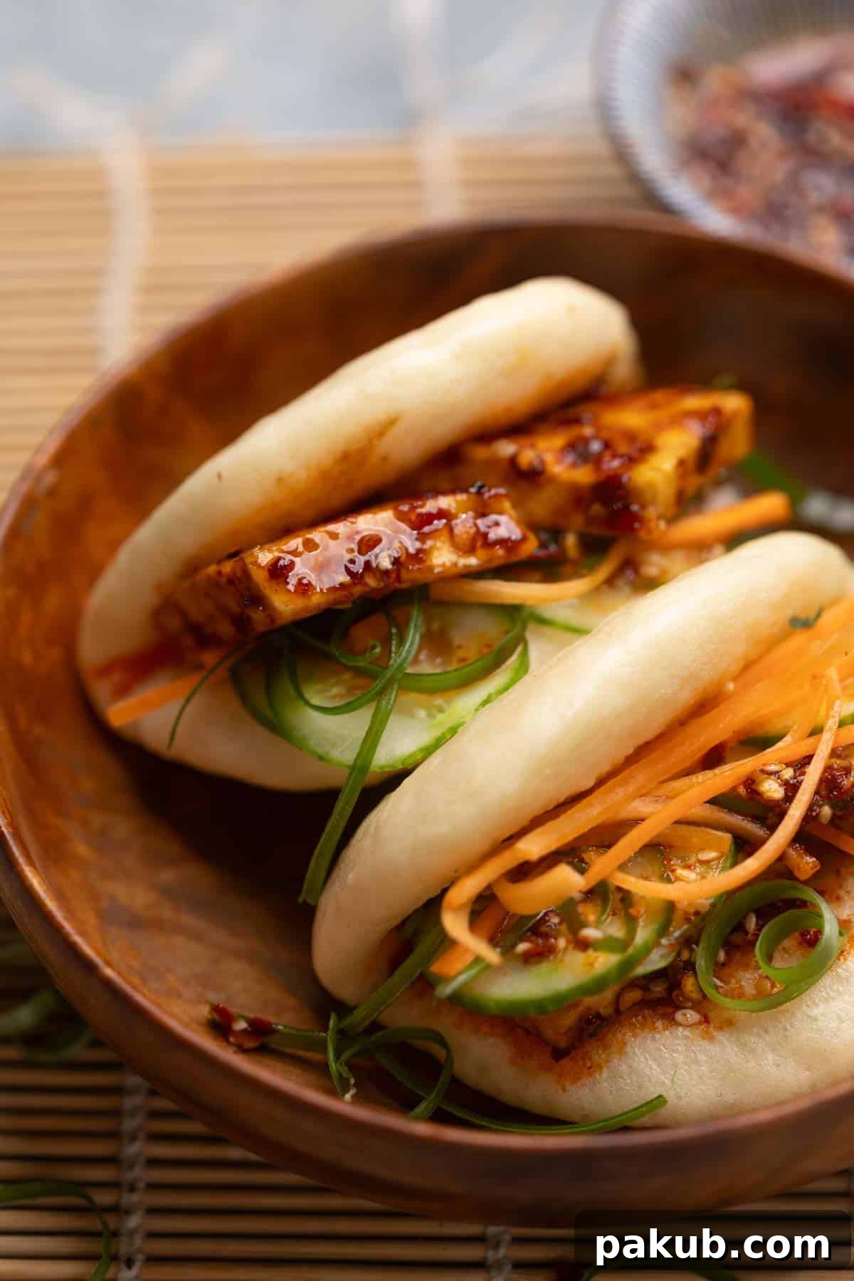 close up image of steamed bao buns served with paneer filling