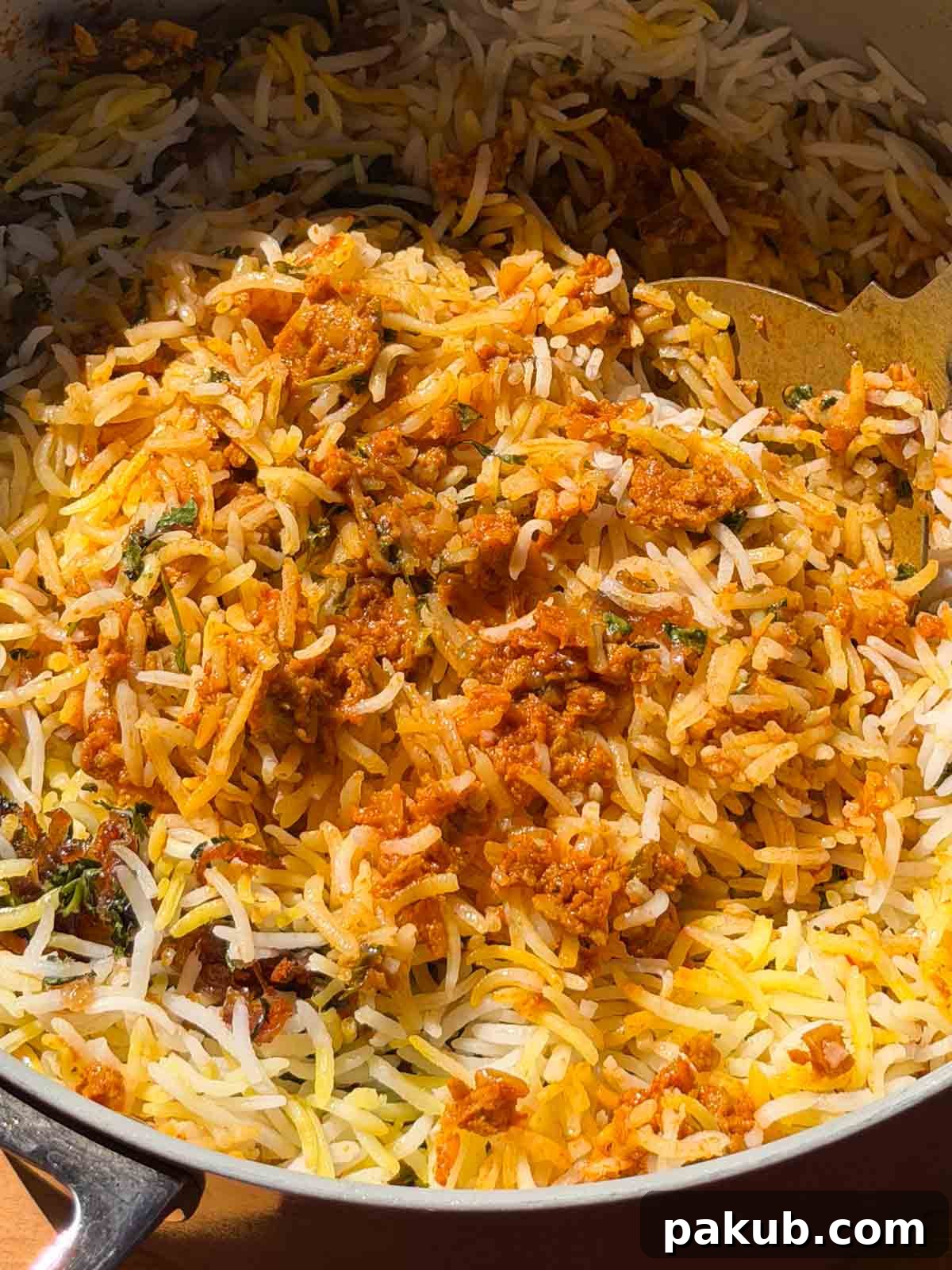 Plant-Based Soya Keema Biryani 4 A close-up of a generous spoonful of soya keema biryani, highlighting the perfect separation of basmati rice grains and the meaty texture of the soya granules.