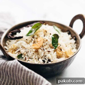 Delicious coconut rice served in a traditional kadhai, generously topped with perfectly roasted cashews and aromatic curry leaves.