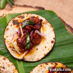 Delectable Mushroom Ghee Roast Tacos served delicately on a green leaf, offering a unique and flavorful fusion.
