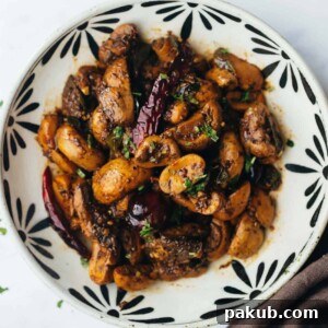 Fragrant Mushroom Pepper Fry served beautifully in a bowl, showcasing its rich texture and tantalizing spices.