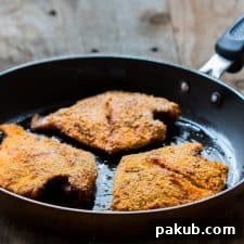 The crispy fried fish, beautifully coated with rava (semolina), glistening in a pan, ready to be devoured.