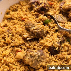 A close-up image of Dindigul Mutton Biryani, showcasing its perfectly cooked, fragrant rice and tender mutton pieces, highlighting its rich texture.