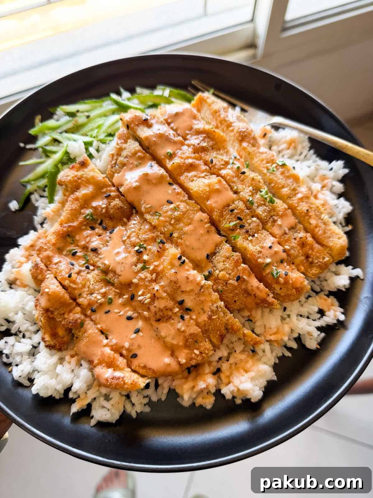 Air-Fried Golden Katsu Rice Bowl 2 Delicious chicken katsu rice bowl served with fresh accompaniments, highlighting the crispy texture and vibrant colors