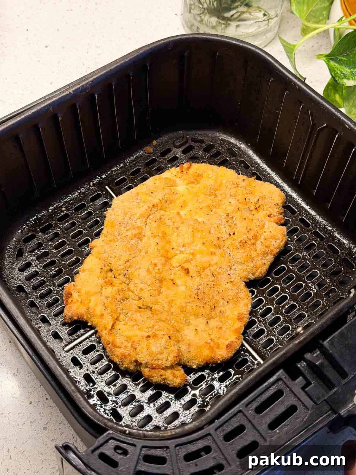 Air-Fried Golden Katsu Rice Bowl 3 Crispy chicken katsu fillet freshly made in the air fryer, perfectly golden brown and ready to be sliced for a rice bowl